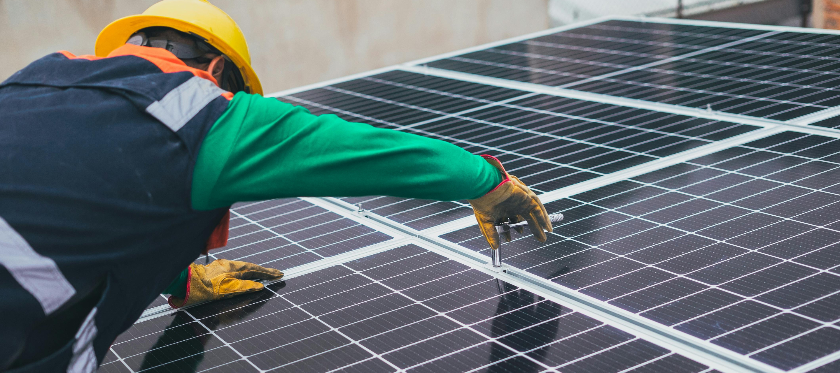 Man fixing a solar pannel